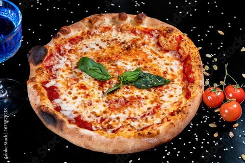 Freshly prepared pizza on dark background