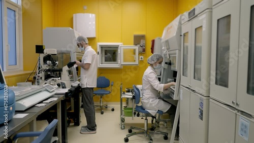 Two doctors working inside the analysis laboratory at the clinic. Conducting medical analysis in the clinic research laboratory. Using modern laboratory equipment for sample analysis at a clinic. photo