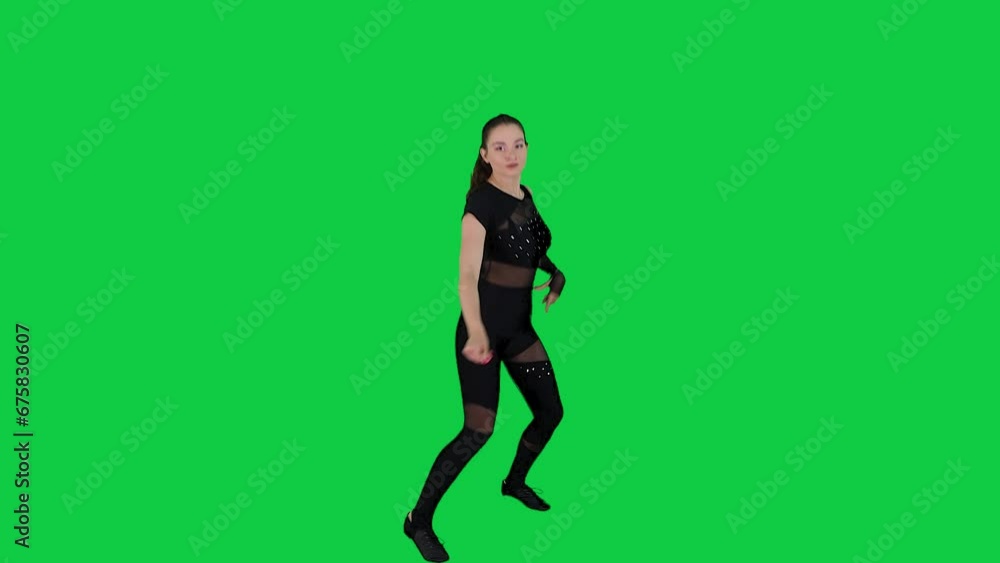 Beautiful and stunning young female dancer dancing in front of green screen in black body suit Beautiful and stunning young female dancer dancing in front of green screen in black body suit