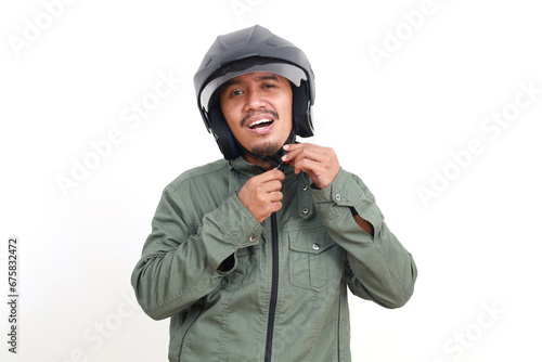 Happy asian man standing while wearing helmet. Isolated on white background photo