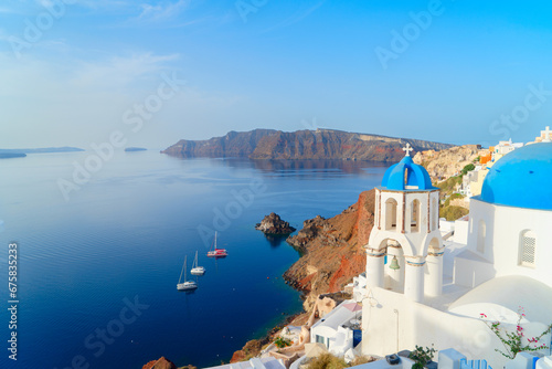 famous blue domes and volcano caldera with deep sea landscape, beautiful details of Oia and Santorini island, Greece photo