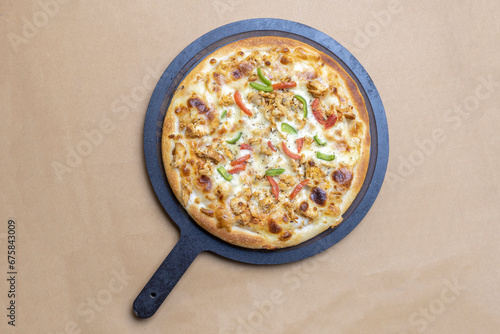 chicken tikka with veggies toppings pizza with wooden pan on green background