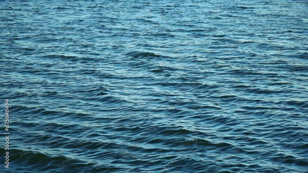 Water surface background for design and decoration. The wind blows waves on the water. Nature abstract footage 4K. Water surface background for design and decoration. The wind blows waves on the water. Nature abstract footage 4K.