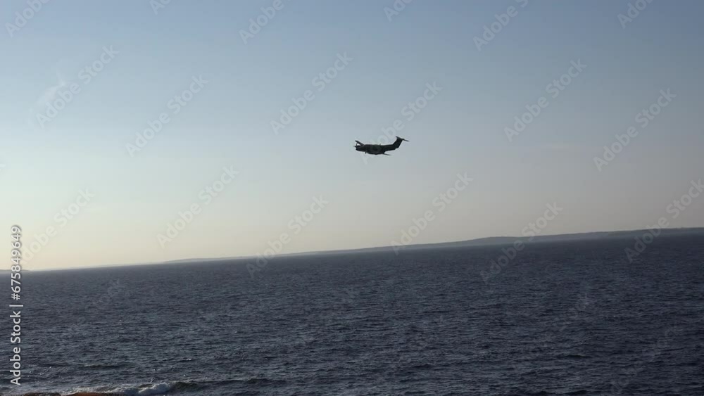 Group of a Military helicopter flying in blue sky over the sea with a lighthouse Group of a Military helicopter flying in blue sky over the sea with a lighthouse