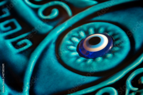 Riental ceramic amulets with the eye. Close up and macro shot. Traditional turkish amulet the eye of fatima. The Blue Turkish Evil Eye Nazar Amulet. photo