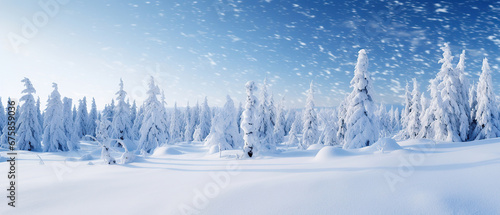 Beautiful ultrawide background image of light snowfall falling over of snowdrifts. © Santy Hong