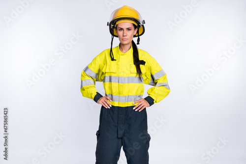 Photo of strong confident young fire lady workwear yellow helmet arms waist isolated white color background