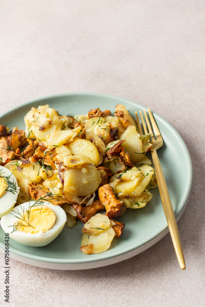 Delicious hearty dinners or lunches, fried young potatoes with forest mushrooms Chanterelles with dill, boiled eggs, seasonal food