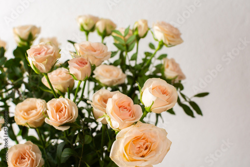 A bouquet of delicate cream roses close up, home decoration with flowers, a festive bouquet of roses for a birthday or wedding © pundapanda