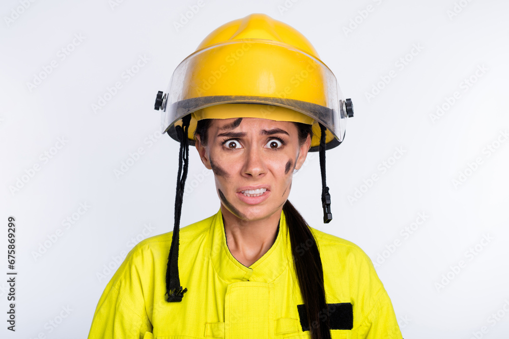 Photo of young woman firefighter afraid scared shocked terrified dangerous isolated over white color background Photo of young woman firefighter afraid scared shocked terrified dangerous isolated over white color background