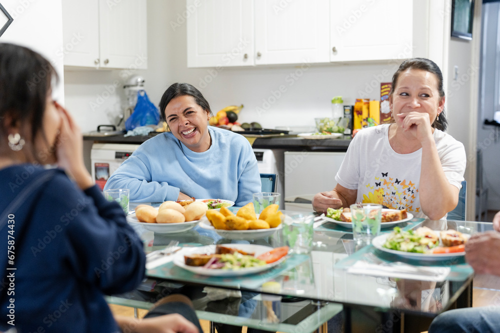 Family sitting at dining table and enjoying lunch