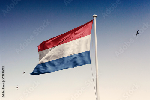 Netherlands flag fluttering in the wind on sky.