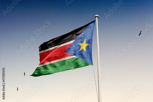 South Sudan flag fluttering in the wind on sky.