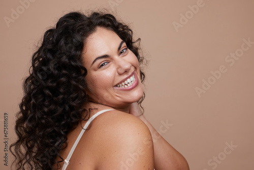Studio portrait of young woman with curly hair
