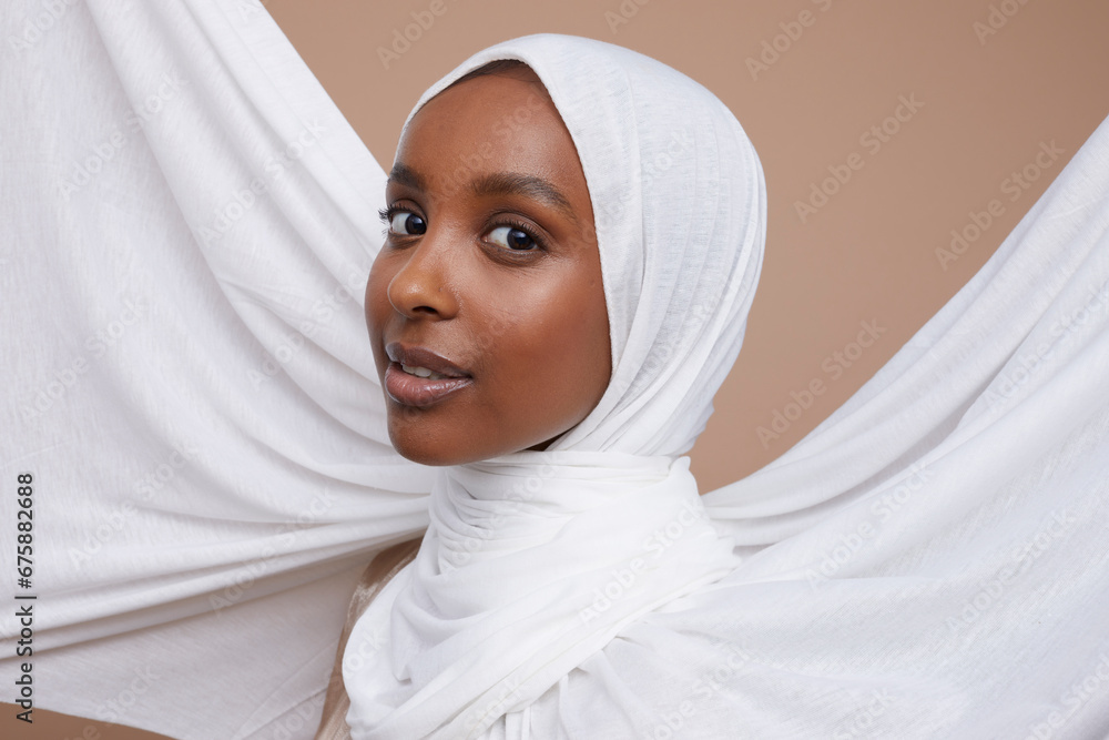 Studio portrait of young woman in white hijab Studio portrait of young woman in white hijab