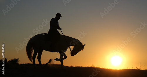 Man on his Camargue Horse at Sunrise, Manadier in Saintes Maries de la Mer in Camargue, in the South of France , Cow Boy