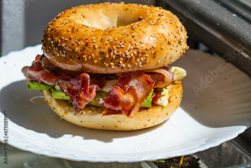 Εκτύπωση καμβά Bacon egg and cheese on a bagel, background image, selective focus close up on t