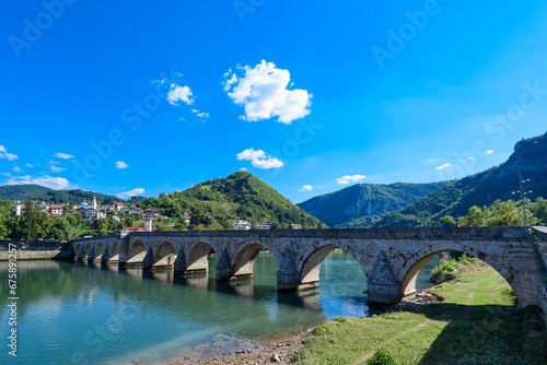 Visegrad, Bosnia and Herzegovina - August 13, 2023: Famous bridge on the Drina in Visegrad, Bosnia and Herzegovina. Mehmed Pasa Sokolovic Bridge on Drina River photo