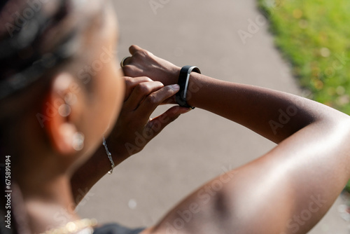 Young woman checking watch after jogging photo