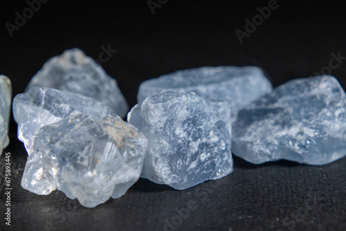 Fototapeta Rocks of rough natural celestite isolated in the dark background