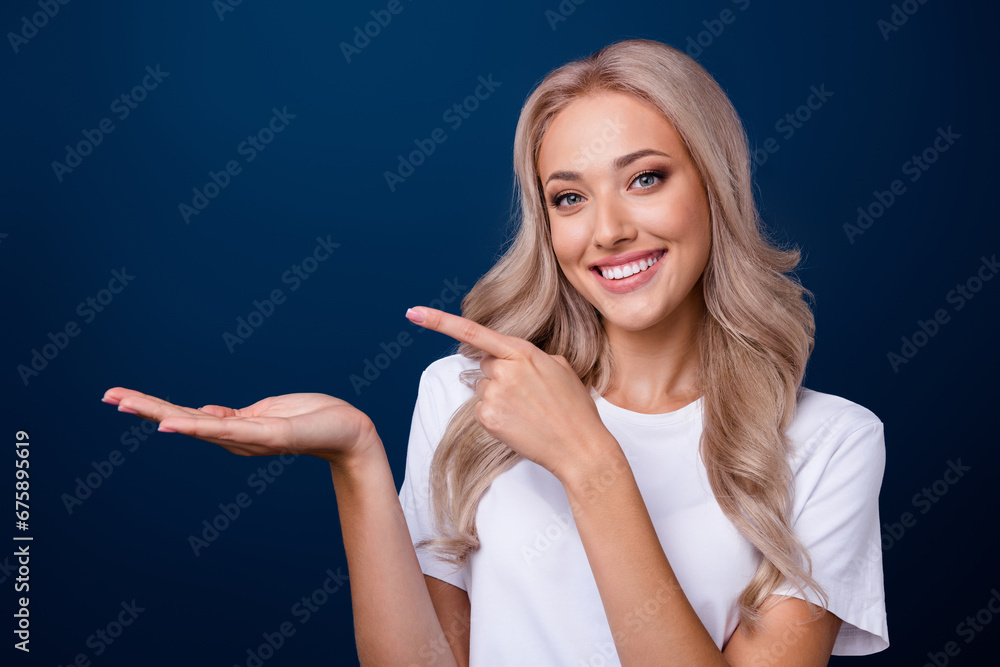 Photo of charming girl bright white teeth wear trendy clothes recommend stomatology empty space isolated on dark blue color background Photo of charming girl bright white teeth wear trendy clothes recommend stomatology empty space isolated on dark blue color background