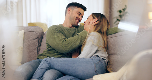 Happy couple, in love and together on sofa in living room for eye contact, trust or bonding. Man, woman and married with embrace for hug in romance, care or comfort in connection on honeymoon in home