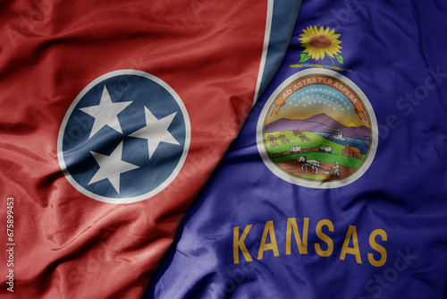 big waving colorful national flag of kansas state and flag of tennessee state .