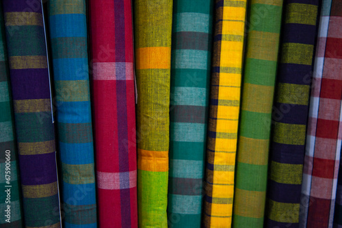 Multicolor Traditional Bangladeshi men's wear lungi folded on a rack in a store. Can be used as  pattern texture background wallpaper