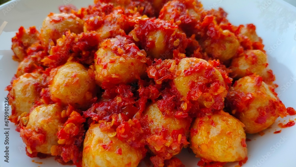 Hot spicy meatballs on a white plate, close up, bakso mercon, bakso pedas, delicious food Hot spicy meatballs on a white plate, close up, bakso mercon, bakso pedas, delicious food