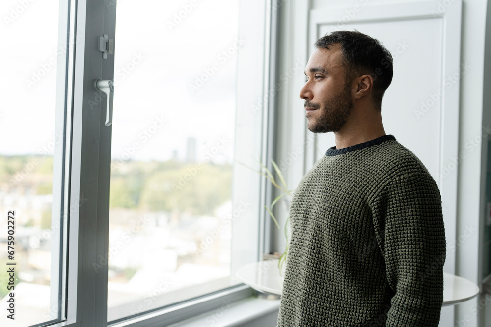 Fototapeta premium Mature man looking through window