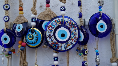 Colorful evil eye beads hanging on the wall photo