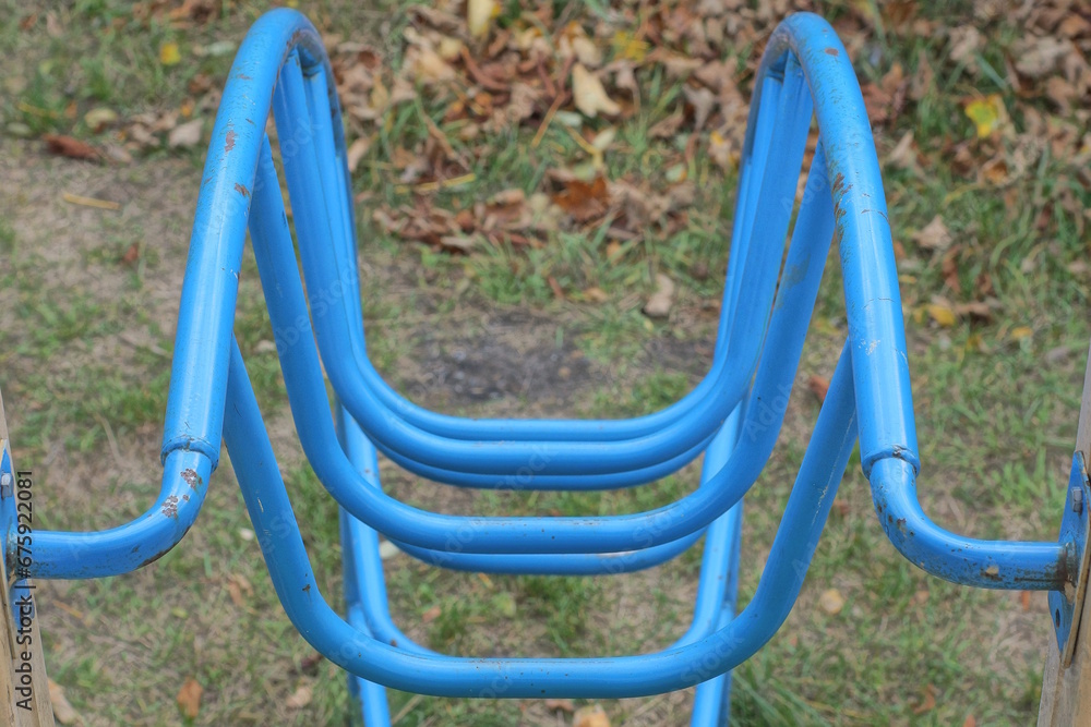 part of a blue metal staircase in a structure on a playground on the street part of a blue metal staircase in a structure on a playground on the street