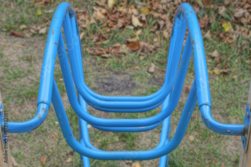part of a blue metal staircase in a structure on a playground on the street