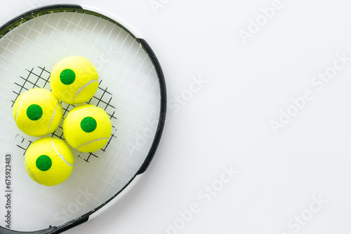 Close up of tennis racquet and balls, top view. Sport games background © 9dreamstudio