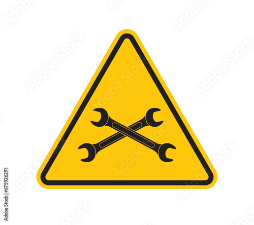 Vector yellow triangle sign - black silhouette crossing wrenches. Isolated on white background.