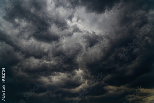 A dark storm cloud closes the sky photo