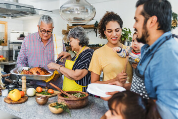 Latin family cooking turkey meat for thanksgiving dinner at home in Mexico Latin America, hispanic people eating at holidays