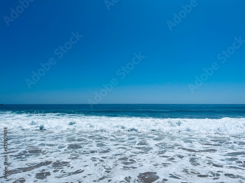 Beautiful ocean coast  waved ocean  surfing  clear blue sky