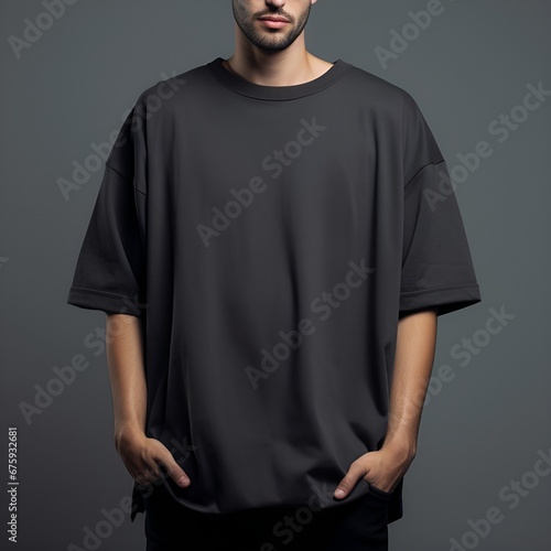 Man in blank black oversize t-shirt for design mockup, front view photo