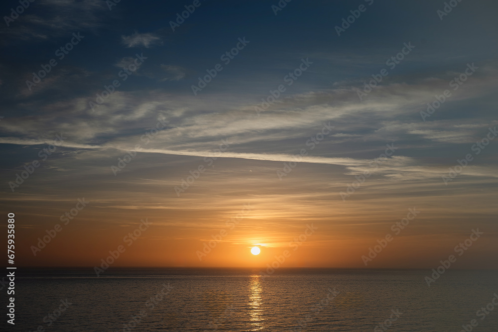Sunset sky clouds vertical over sea in the evening with colorful orange sunlight reflect on the sea landscape with summer travel concept. Sunset sky clouds vertical over sea in the evening with colorful orange sunlight reflect on the sea landscape with summer travel concept.