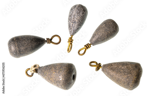 Photography A collection of lead fishing weights with brass eyelets on a clean background