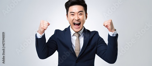 In a white isolated office a successful Asian businessman with a happy smile poses for a portrait showcasing the concept of business background and the power of people s hand to achieve succ photo