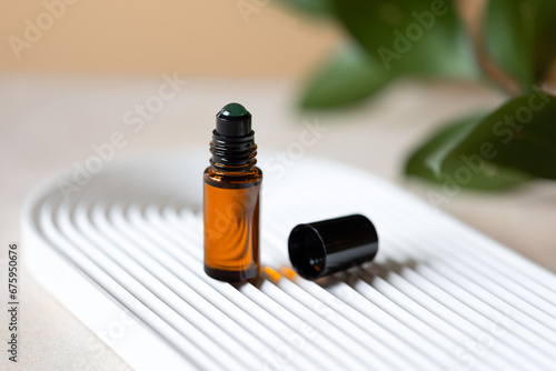 Dark glass aroma rollerball with natural aventurine stone, aromatherapy with essential oils.