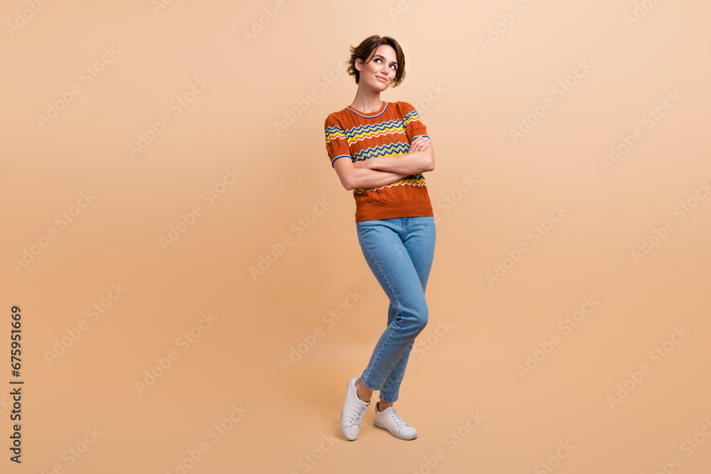 Full size portrait of minded gorgeous girl folded hands look empty space brainstorming isolated on beige color background Full size portrait of minded gorgeous girl folded hands look empty space brainstorming isolated on beige color background