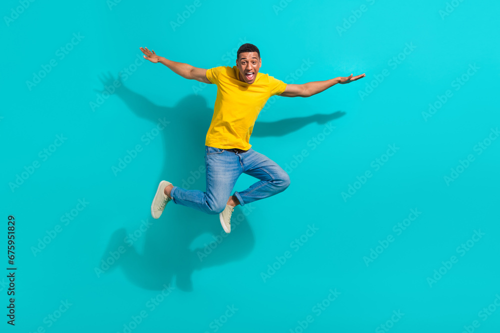 Full body photo of overjoyed cheerful young person jumping flying have good mood isolated on bright teal color background