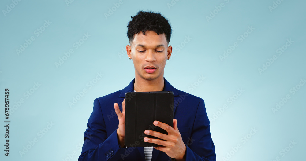 Man in studio, typing on tablet for business ideas and research for creative startup schedule. Thinking, agenda and professional person with digital app, scroll and social media on blue background. Man in studio, typing on tablet for business ideas and research for creative startup schedule. Thinking, agenda and professional person with digital app, scroll and social media on blue background.