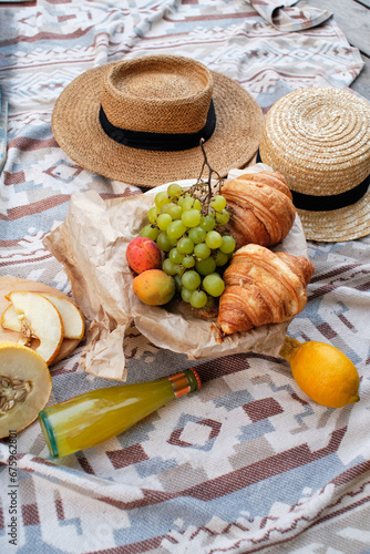 still life. Summer picnic with fruits and croissants.