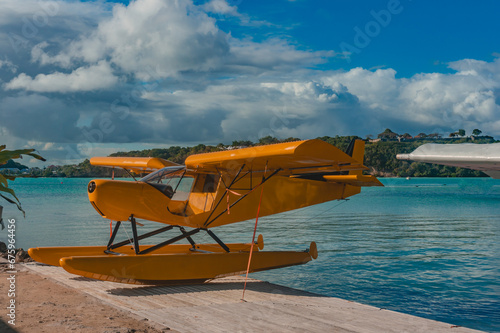 Fototapeta Naklejka Na Ścianę i Meble -  Seaplane on the bank with sea on the background under a cloudy sky, Gosier, Guadeloupe, French West-Indies