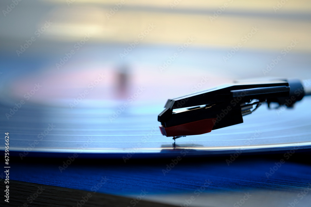 Vinyl record player with record on the background morning light from window with blinds. Vinyl record player with record on the background morning light from window with blinds.