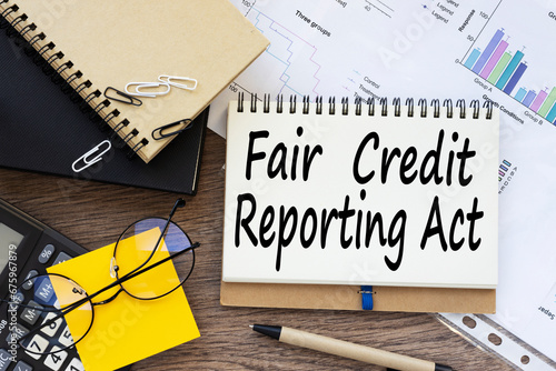 Fair credit reporting act FCRA on a desk. yellow sticker on the calculator. financial charts. text on the envelope photo